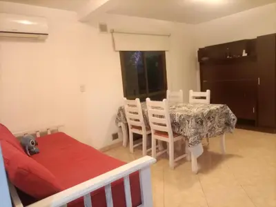a living room with a table and a table and chairs at Departamento en Villa Carlos Paz in Villa Carlos Paz