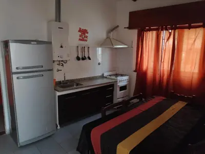 a small kitchen with a refrigerator and a sink at Alquileres centro Mina Clavero in Mina Clavero