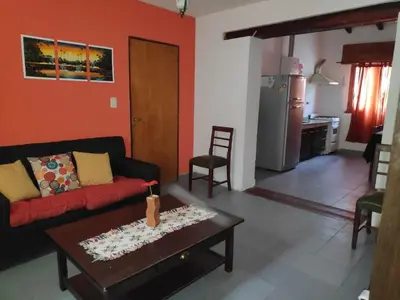 a living room with a couch and a table at Alquileres centro Mina Clavero in Mina Clavero