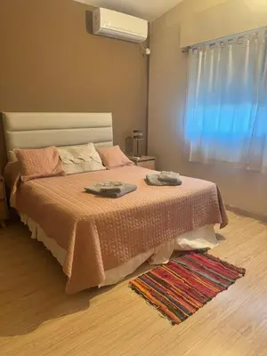 a bedroom with a bed with two towels on it at Casa Tati in Santa Rosa de Calamuchita