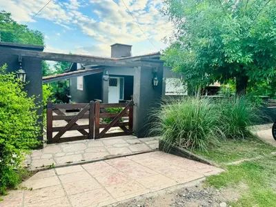 a house with a gate and a fence at Casa Tati in Santa Rosa de Calamuchita