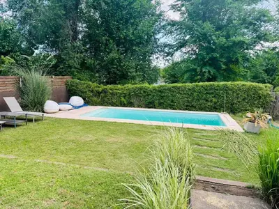 a small swimming pool in a yard with grass at Casa Tati in Santa Rosa de Calamuchita