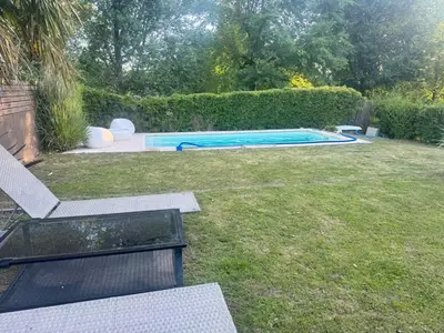 a backyard with a swimming pool in the grass at Casa Tati in Santa Rosa de Calamuchita
