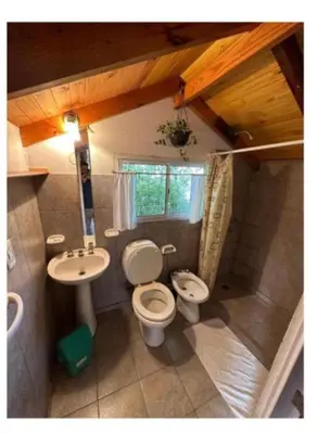 a small bathroom with a toilet and a sink at HOSTEL CASA C Alojamiento, Coworking y Centro Cultural in Villa General Belgrano