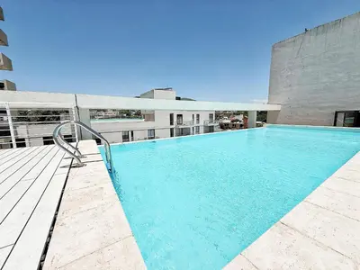 a swimming pool on the roof of a building at Edificio Lake Tower in Villa Carlos Paz