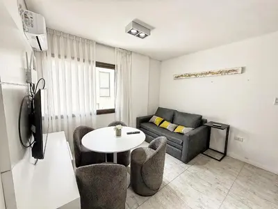 a living room with a couch and a table at Edificio Lake Tower in Villa Carlos Paz