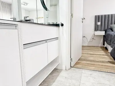 a bathroom with a sink and a mirror at Edificio Lake Tower in Villa Carlos Paz