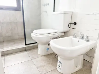 a bathroom with a toilet and a sink at Edificio Lake Tower in Villa Carlos Paz