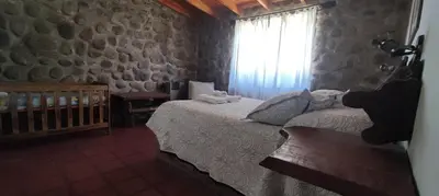 a bedroom with a bed and a window at Cabañas La Morada in Nono