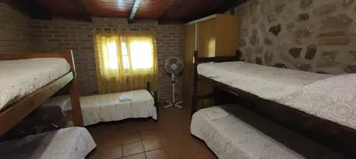 a room with two bunk beds and a window at Cabañas La Morada in Nono