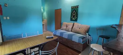 a living room with a couch and a table and chairs at Cabañas La Morada in Nono