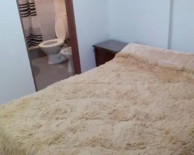 a bedroom with a bed and a bathroom with a toilet at Super Depto Balcarce 455 in Cordoba