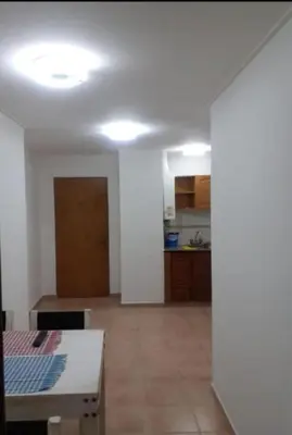 a living room with a table and a kitchen at Super Depto Balcarce 455 in Cordoba