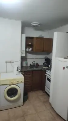 a kitchen with a stove and a white refrigerator at Super Depto Balcarce 455 in Cordoba