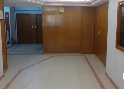 an empty room with wooden doors in a building at Super Depto Balcarce 455 in Cordoba