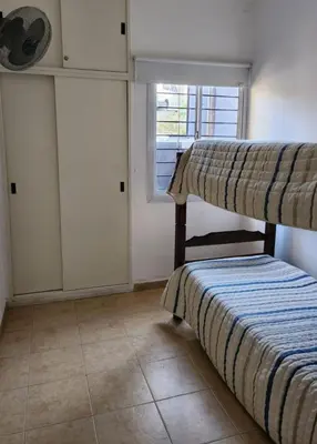 a bedroom with two bunk beds and a window at Quadro Departamentos in Villa Carlos Paz