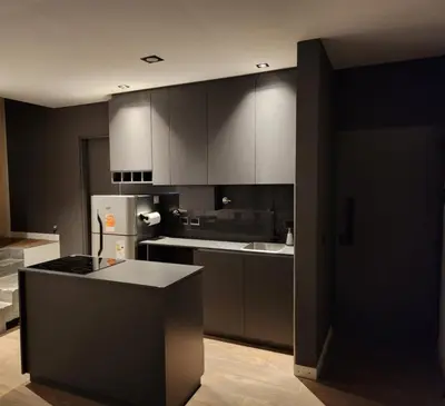 a kitchen with white cabinets and a white refrigerator at Quadro Departamentos in Villa Carlos Paz
