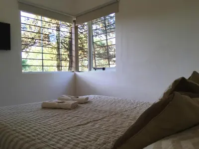 a bedroom with a bed with two towels on it at Quadro Departamentos in Villa Carlos Paz