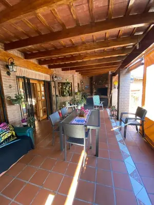 a patio with a table and chairs on a house at Chalet espectacular in Villa Carlos Paz