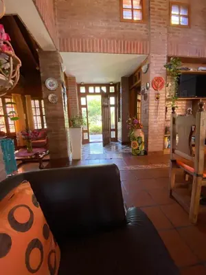 a living room with a couch and chairs in a room at Chalet espectacular in Villa Carlos Paz