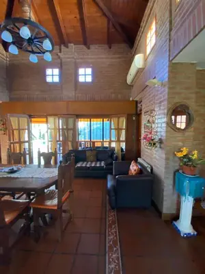 a living room with a couch and a table at Chalet espectacular in Villa Carlos Paz