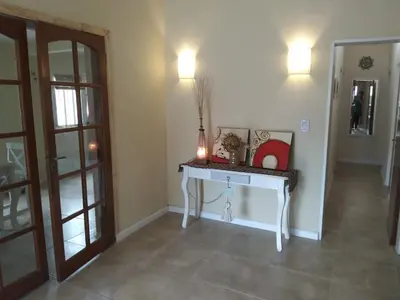 a room with a table with a vase on it at Chalet privado hasta 8 personas con pileta in La Cuesta