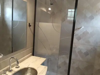 a bathroom with a sink and a shower at Chalet privado hasta 8 personas con pileta in La Cuesta