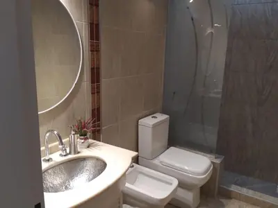 a bathroom with a sink and a toilet and a shower at Chalet privado hasta 8 personas con pileta in La Cuesta