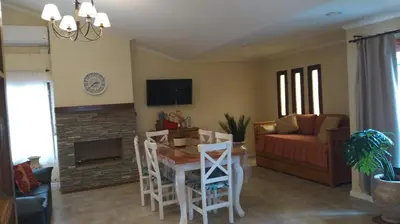 a living room with a table and a couch at Chalet privado hasta 8 personas con pileta in La Cuesta