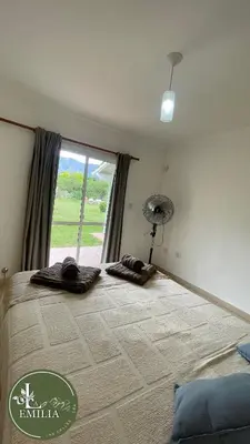 a bedroom with a large bed with a window at La Emilia in Las Rabonas