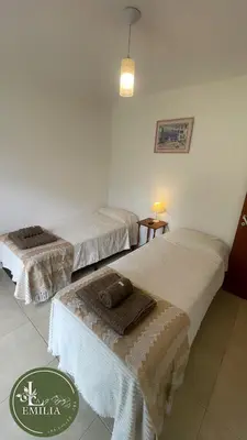 a room with two beds with towels on them at La Emilia in Las Rabonas