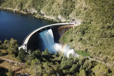 a train is going through a bridge over a river at Cabaña los cuates in Villa Ciudad Parque