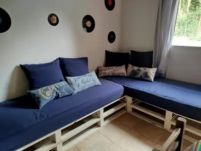 a room with two blue futon beds with pillows at Cabaña los cuates in Villa Ciudad Parque