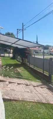 awning over a yard with a fence and grass at casa balcon del sol in Villa Carlos Paz