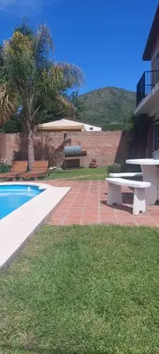 a swimming pool with a picnic table and a bench at casa balcon del sol in Villa Carlos Paz