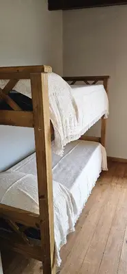 two bunk beds in a room with a wooden floor at Complejo MASVISTA in San Antonio de Arredondo