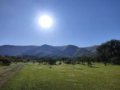 a view of a field with mountains in the background at Complejo MASVISTA in San Antonio de Arredondo