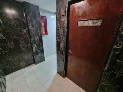 a wooden door in a bathroom with a tile floor at Chacabuco Confort - Bienes Reales in Cordoba