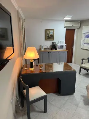 a desk with a lamp and a chair in a room at Spilimbergo's Home in Cordoba