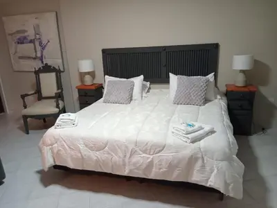 a bedroom with a large white bed with towels on it at Spilimbergo's Home in Cordoba