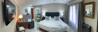 a bedroom with a large bed and a mirror at Spilimbergo's Home in Cordoba