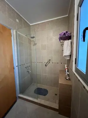 a bathroom with a shower with a glass door at Mansion de Potrero in La Estancia