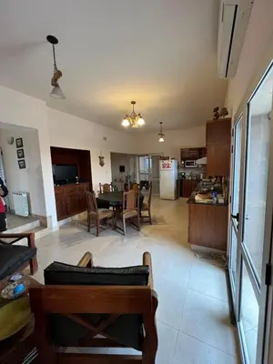 a living room and kitchen with a table and chairs at Mansion de Potrero in La Estancia