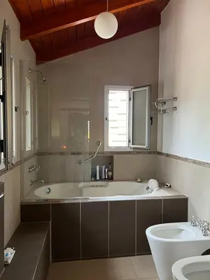 a large bathroom with a tub and a sink at Mansion de Potrero in La Estancia