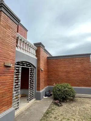 a brick building with an open door in a yard at Mansion de Potrero in La Estancia