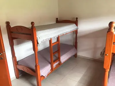 a couple of bunk beds in a room at Cabañas Luciano in Arroyo de Los Patos