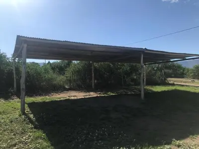 a metal pavilion with a roof on a field at Cabañas Luciano in Arroyo de Los Patos
