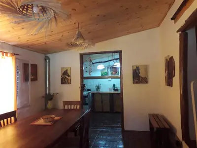 a dining room with a table and a kitchen at La Rustica in El Durazno