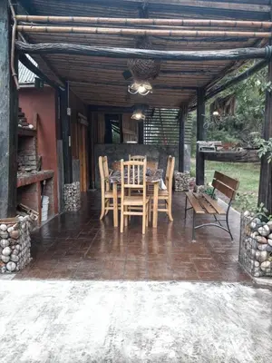 a patio with a table and chairs on a patio at La Rustica in El Durazno