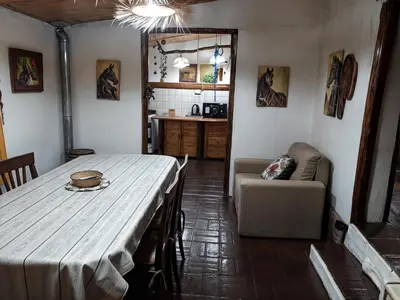a living room with a table and a couch at La Rustica in El Durazno
